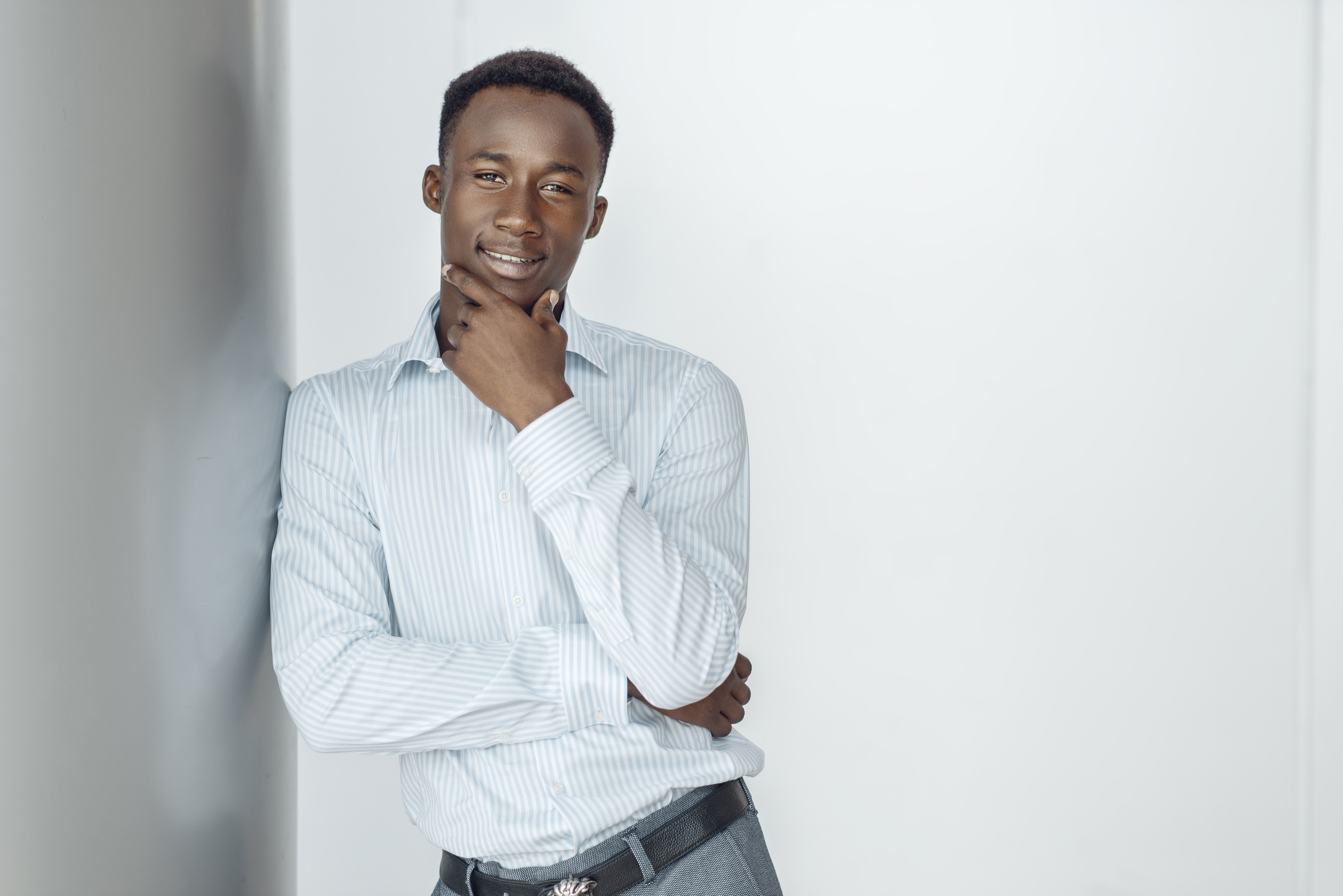 Ebony Businessman Poses in Office Building